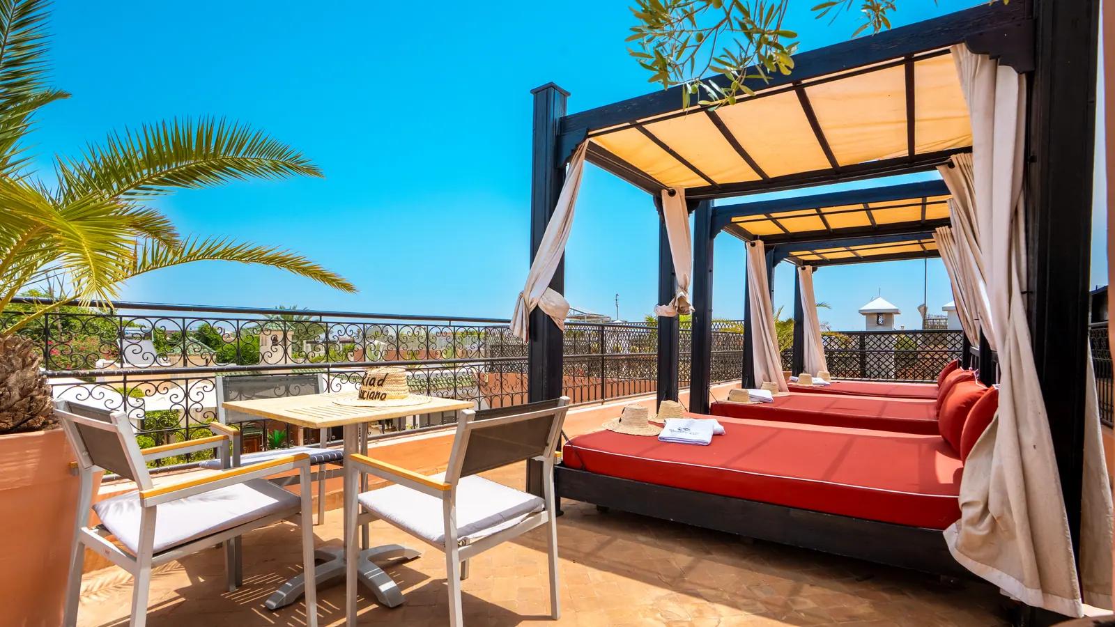 Red lounge beneath the rooftop pergola