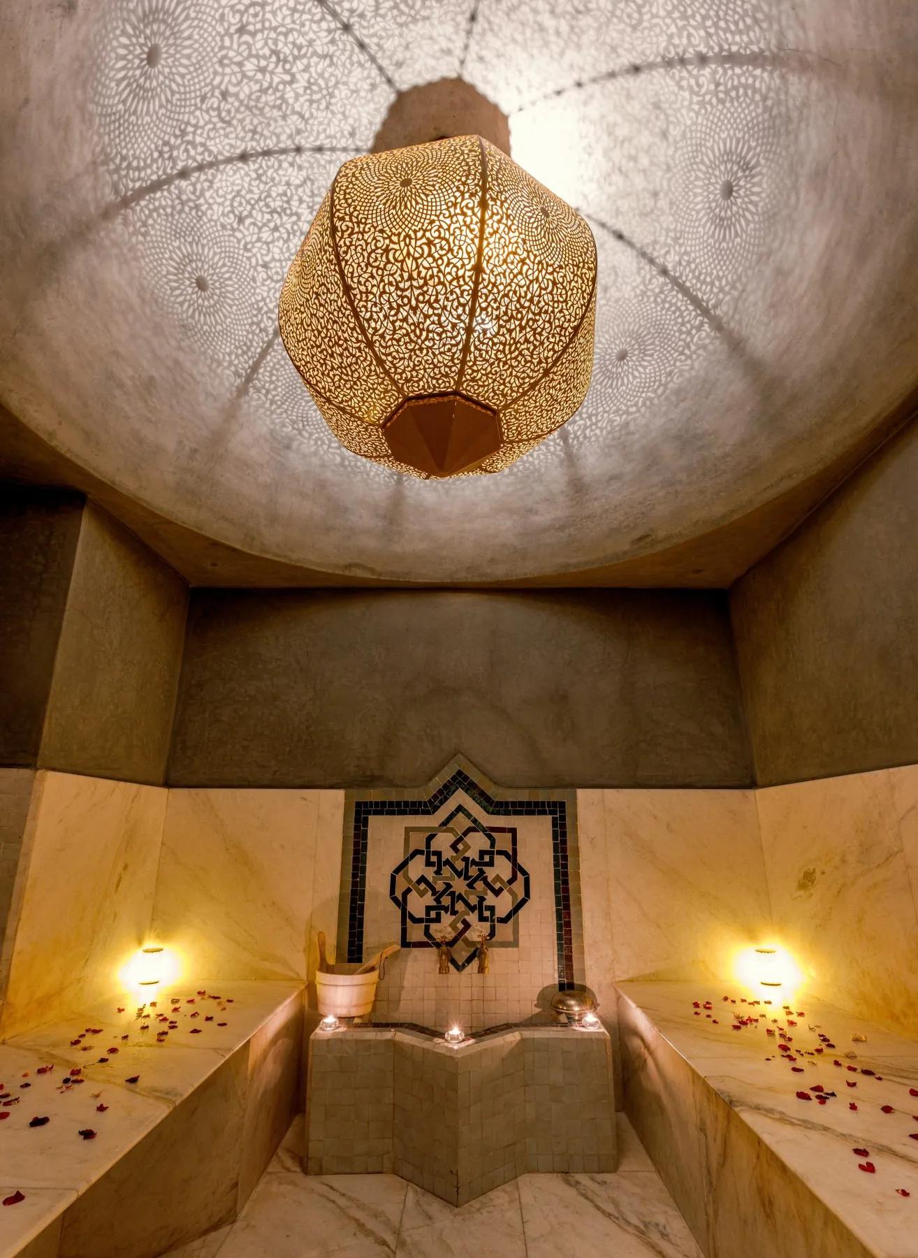 Hammam with a Moroccan lantern and marble benches