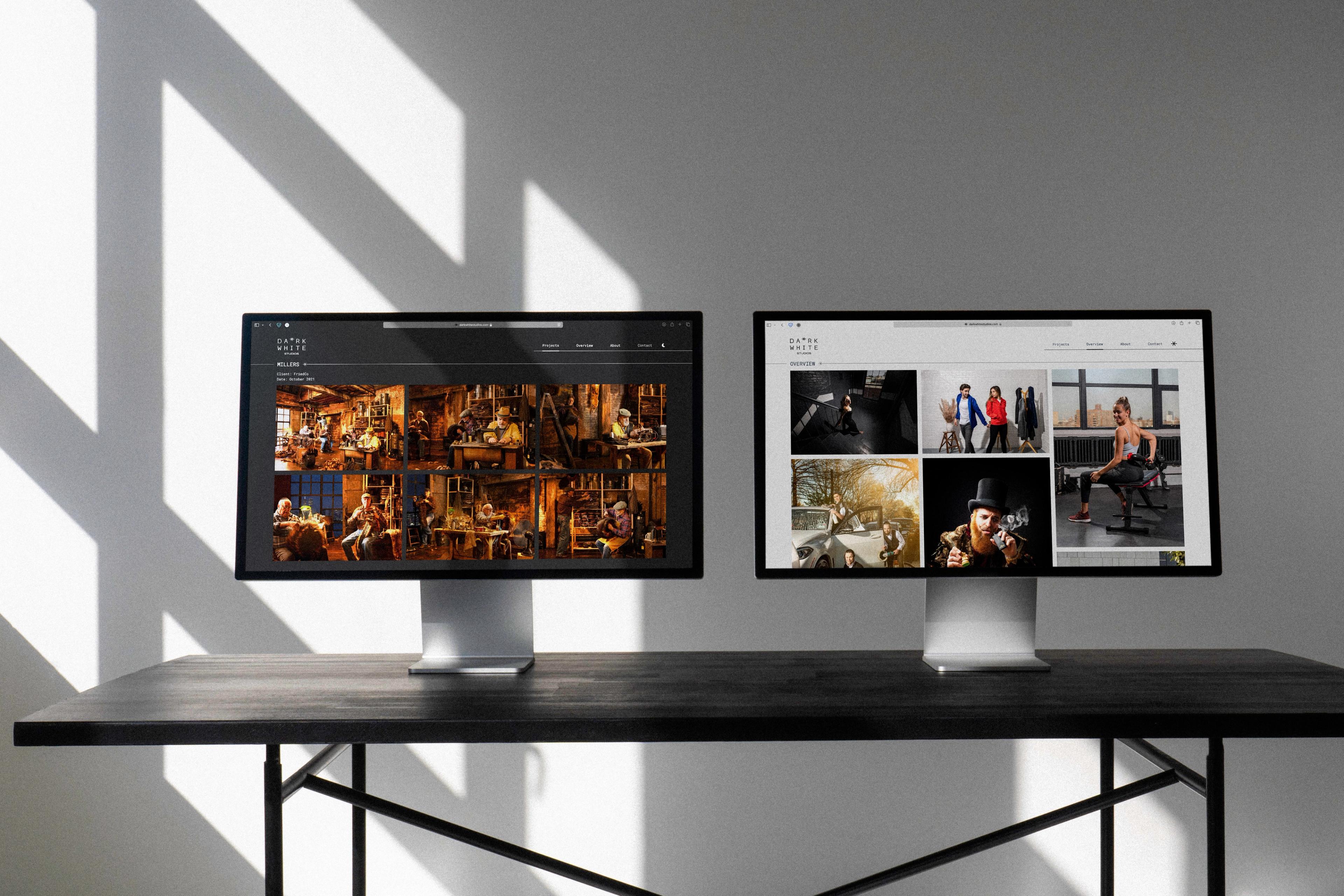 Dark White Studios: Two monitors displaying photography galleries.