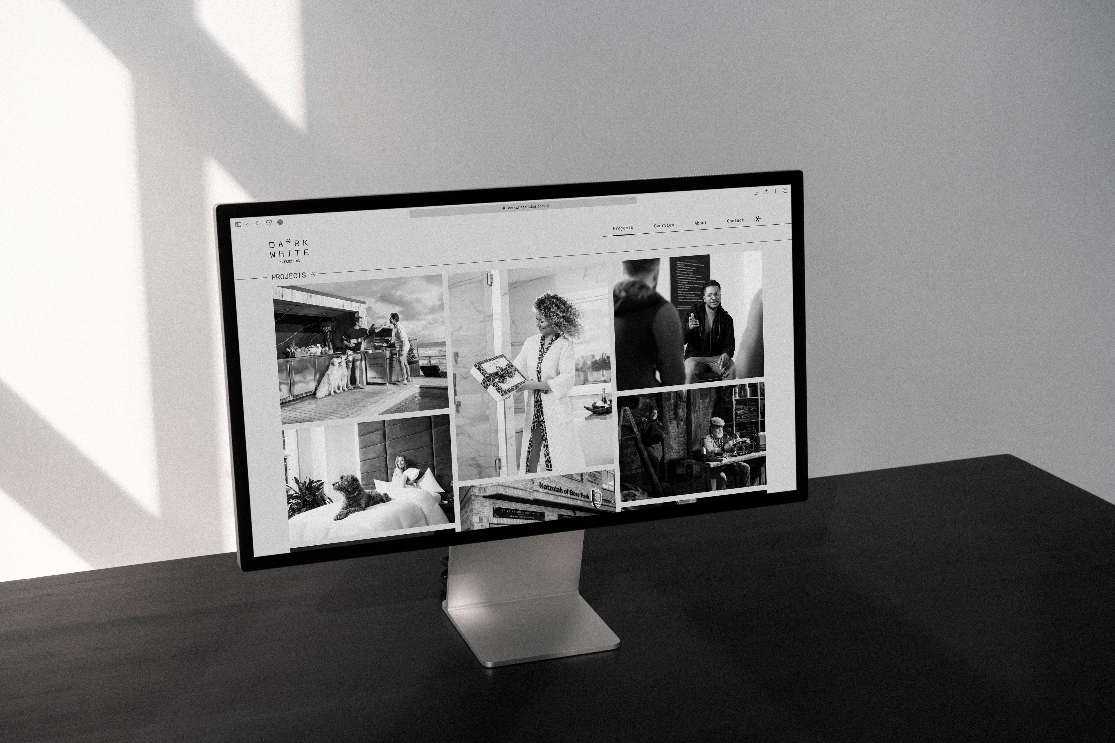 Dark White Studios: Photography portfolio displayed on a desktop monitor.