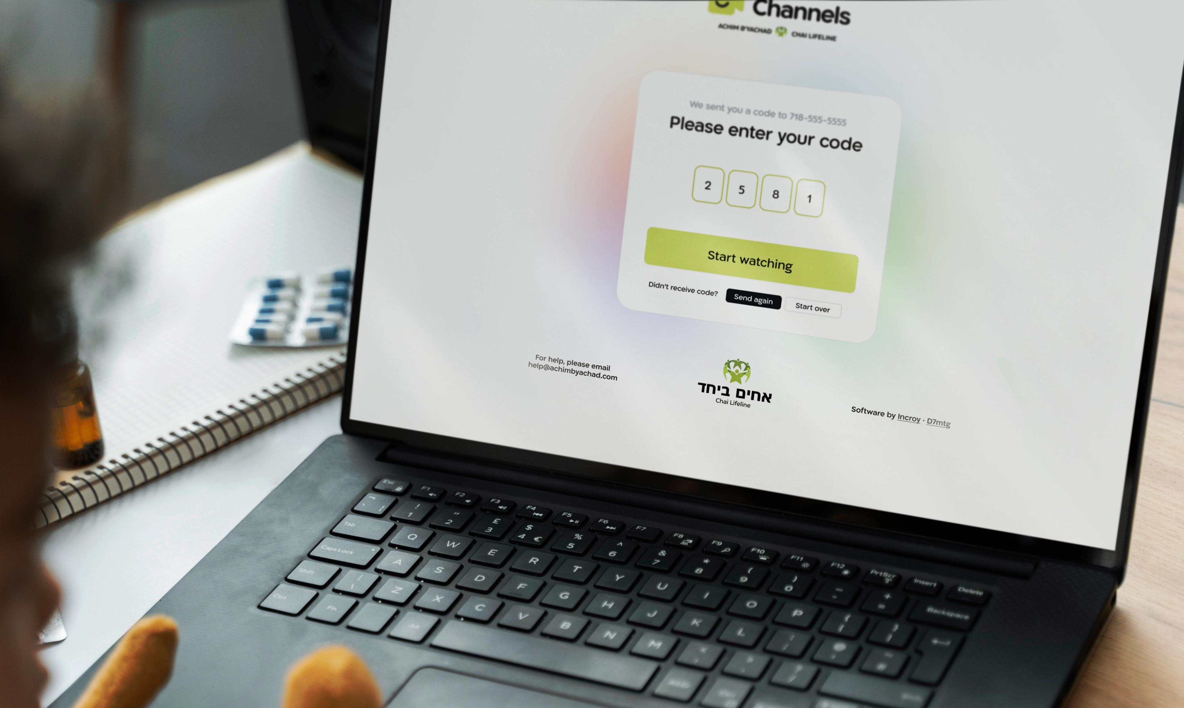 Channels: Hebrew login page displayed on a laptop.