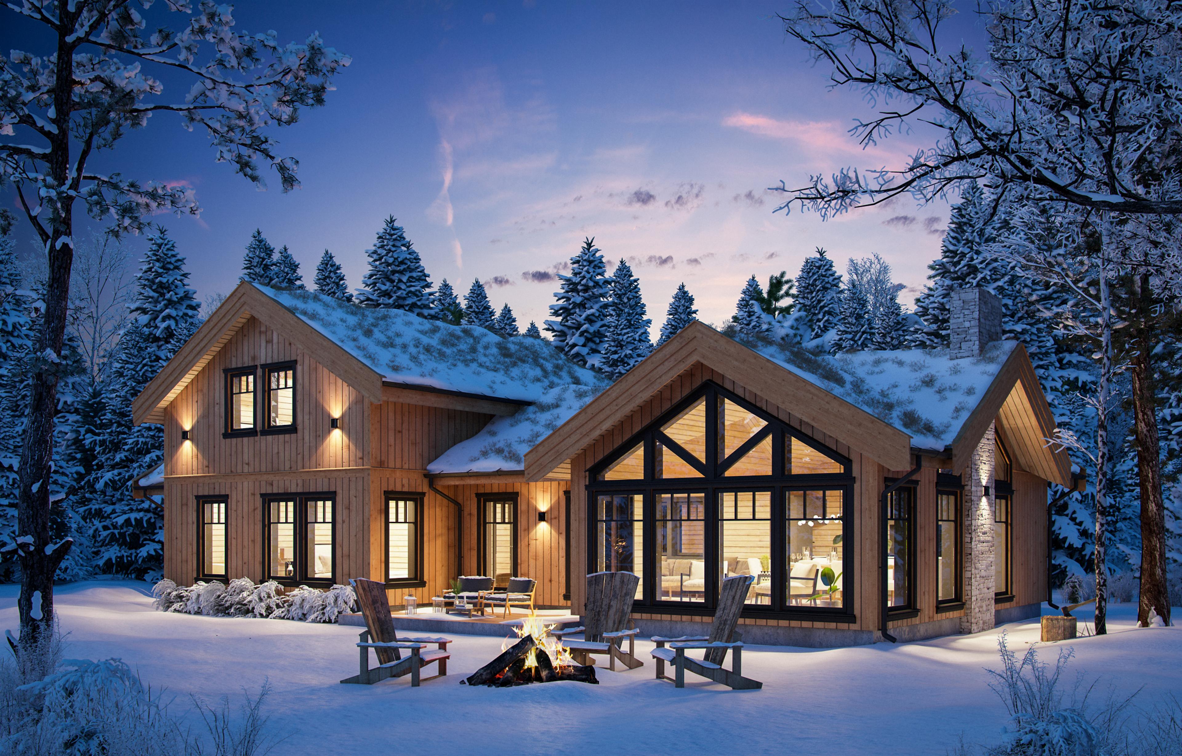 Moderne hytte i vinterlandskap og kveldslys