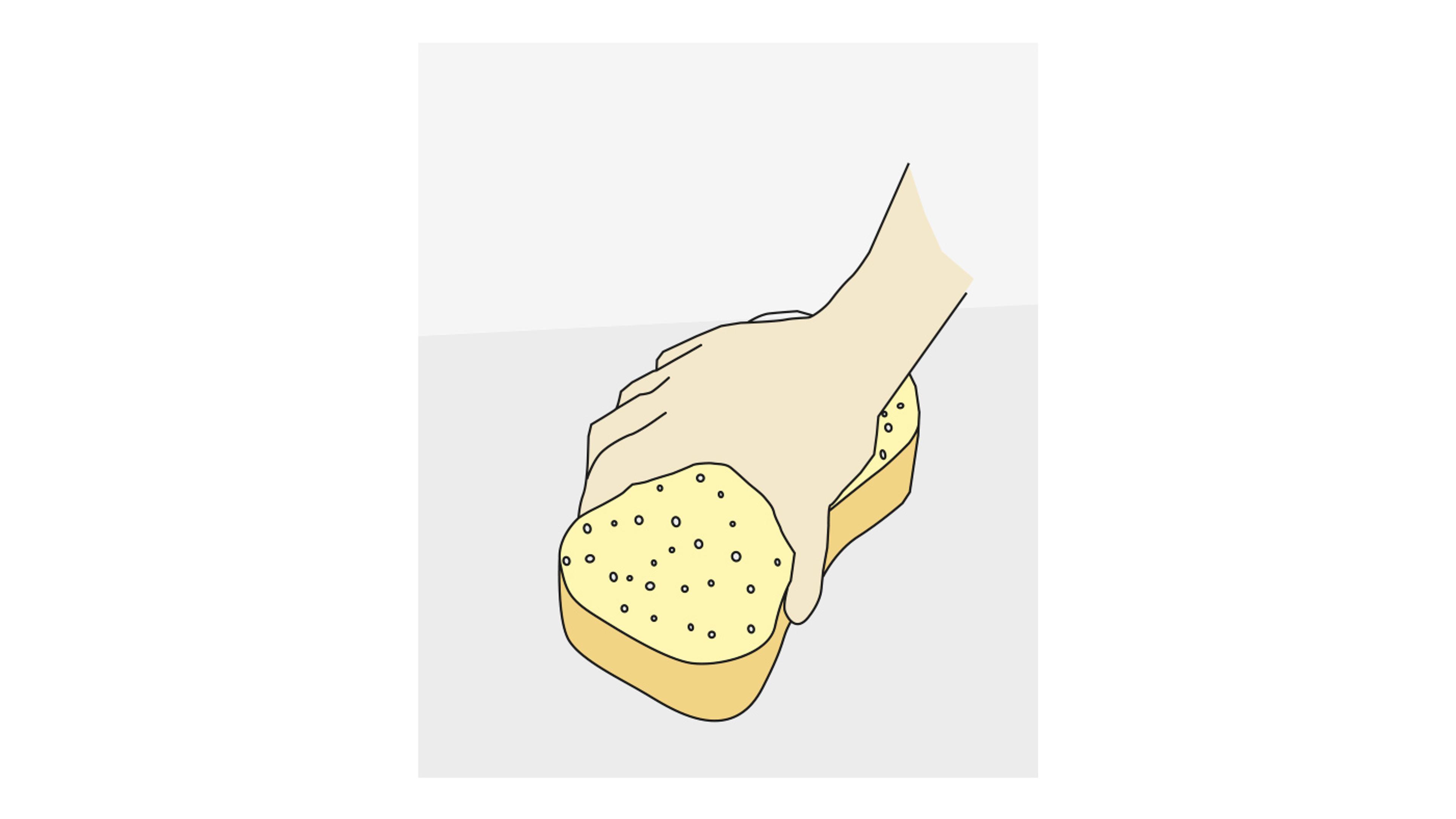Hand som trycker på en gul svamp