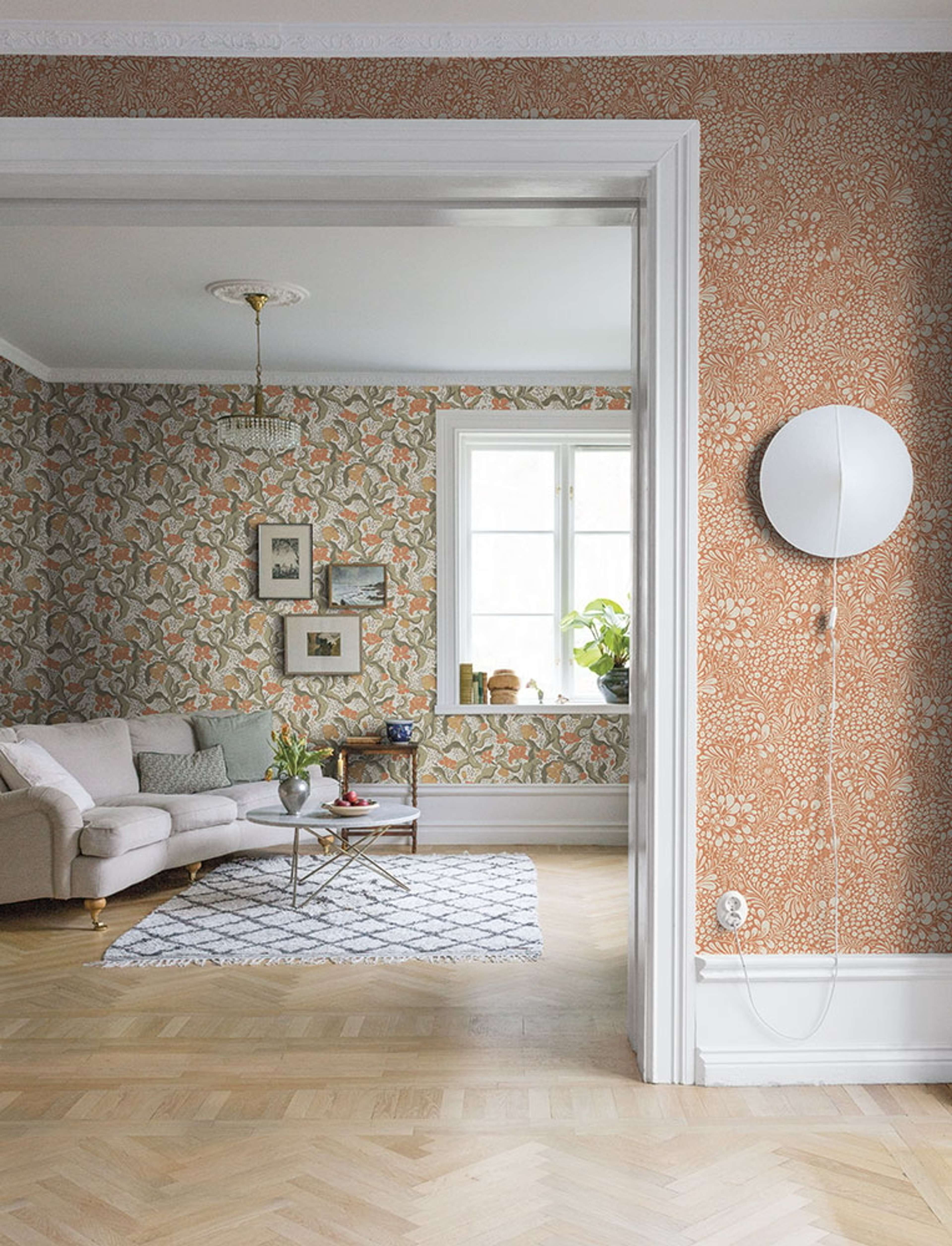 Bodri blommor och blad i grönt och orange tapet med blommigt mönster i grön och orange. Från kollektionen Lina 2. Nonwoven-material med förskjuten passning.