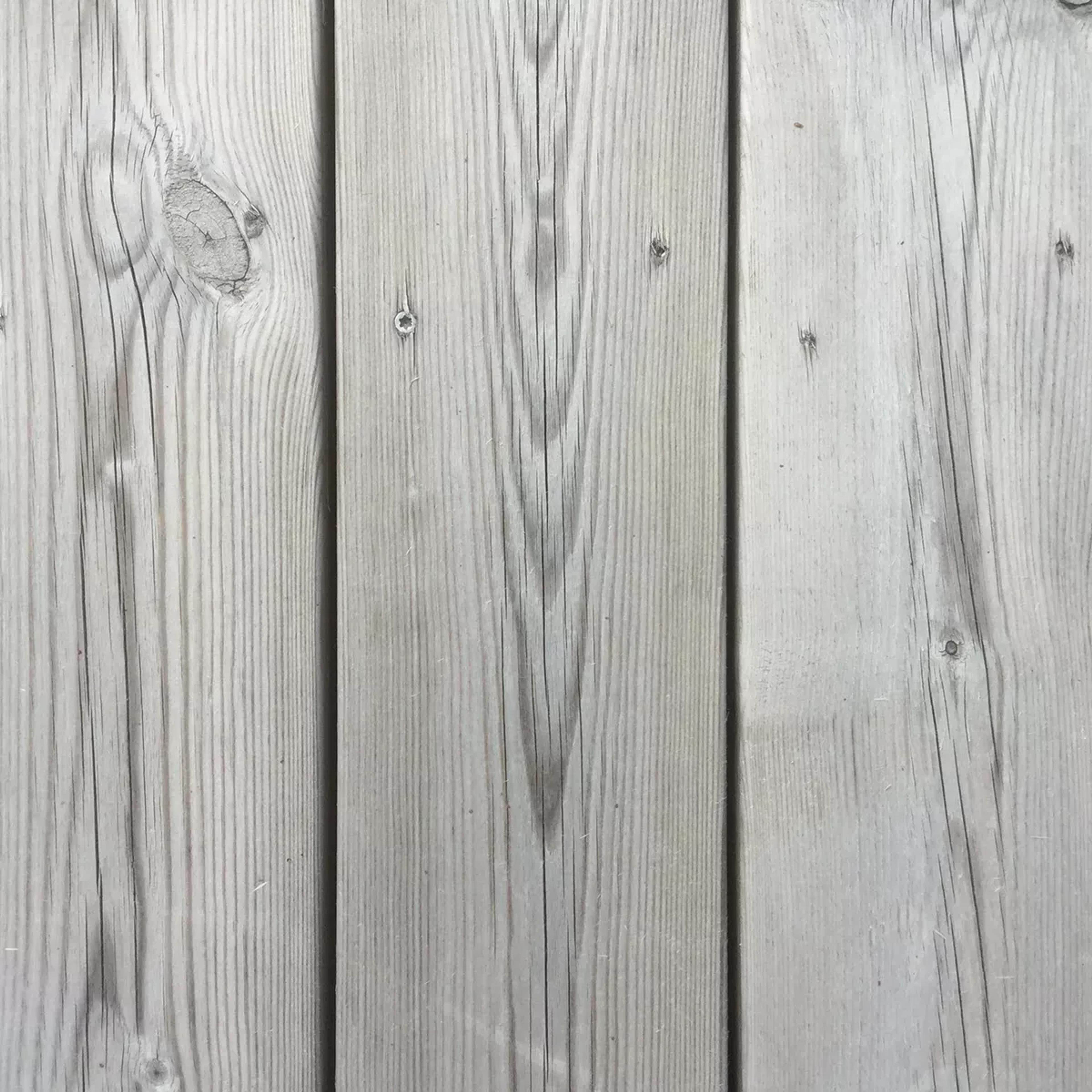 Light gray vertical wood planks with visible grain and knots.