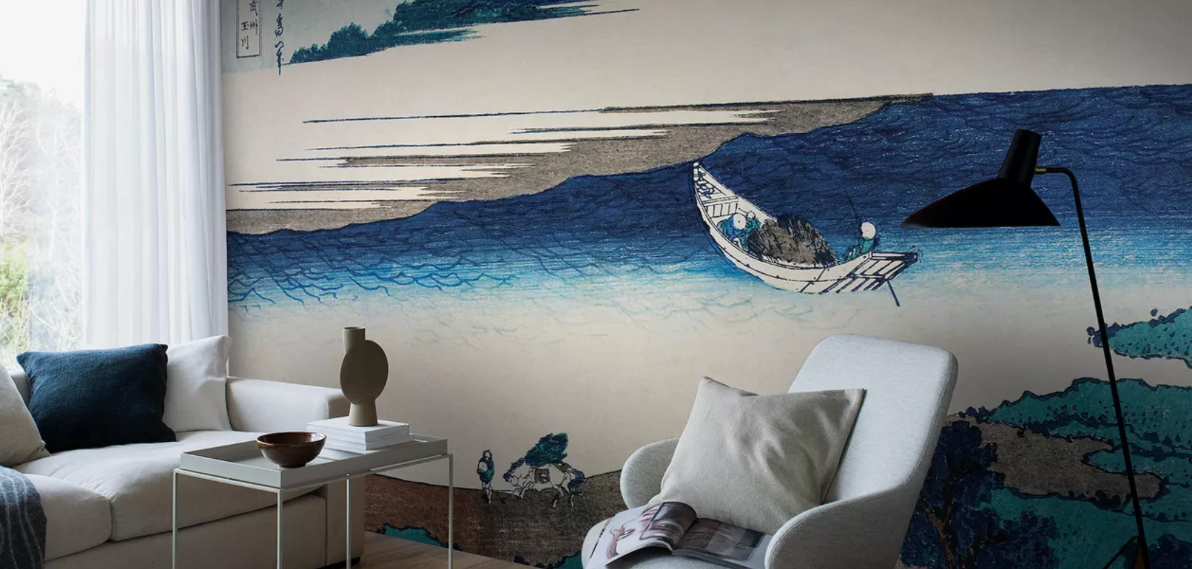 A modern living room featuring a large wall mural of a boat on blue waves in the style of a Japanese woodblock print.