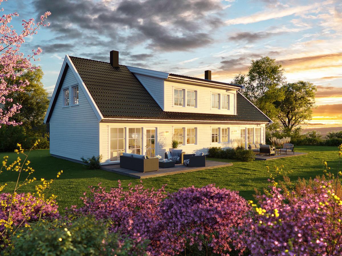 Et hvitt hus med svart tak i solnedgang