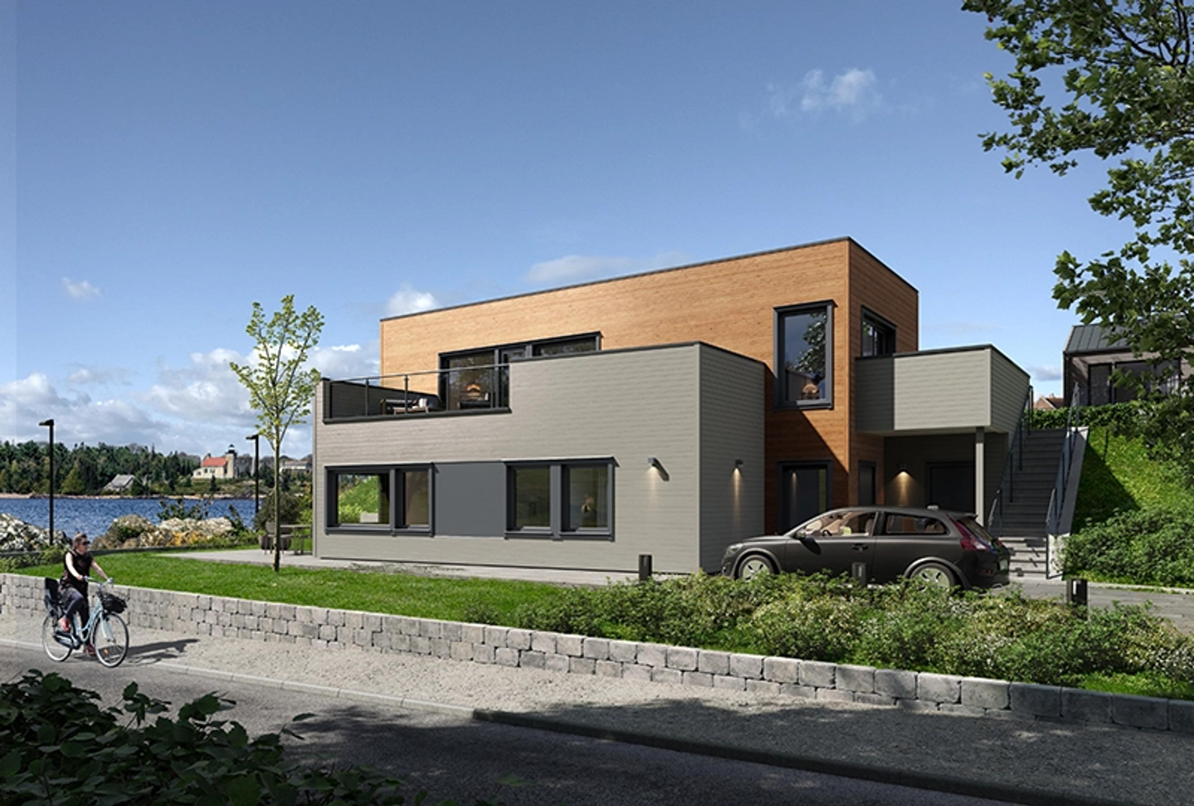 En moderne bolig over to etasjer med flatt tak og to balkonger