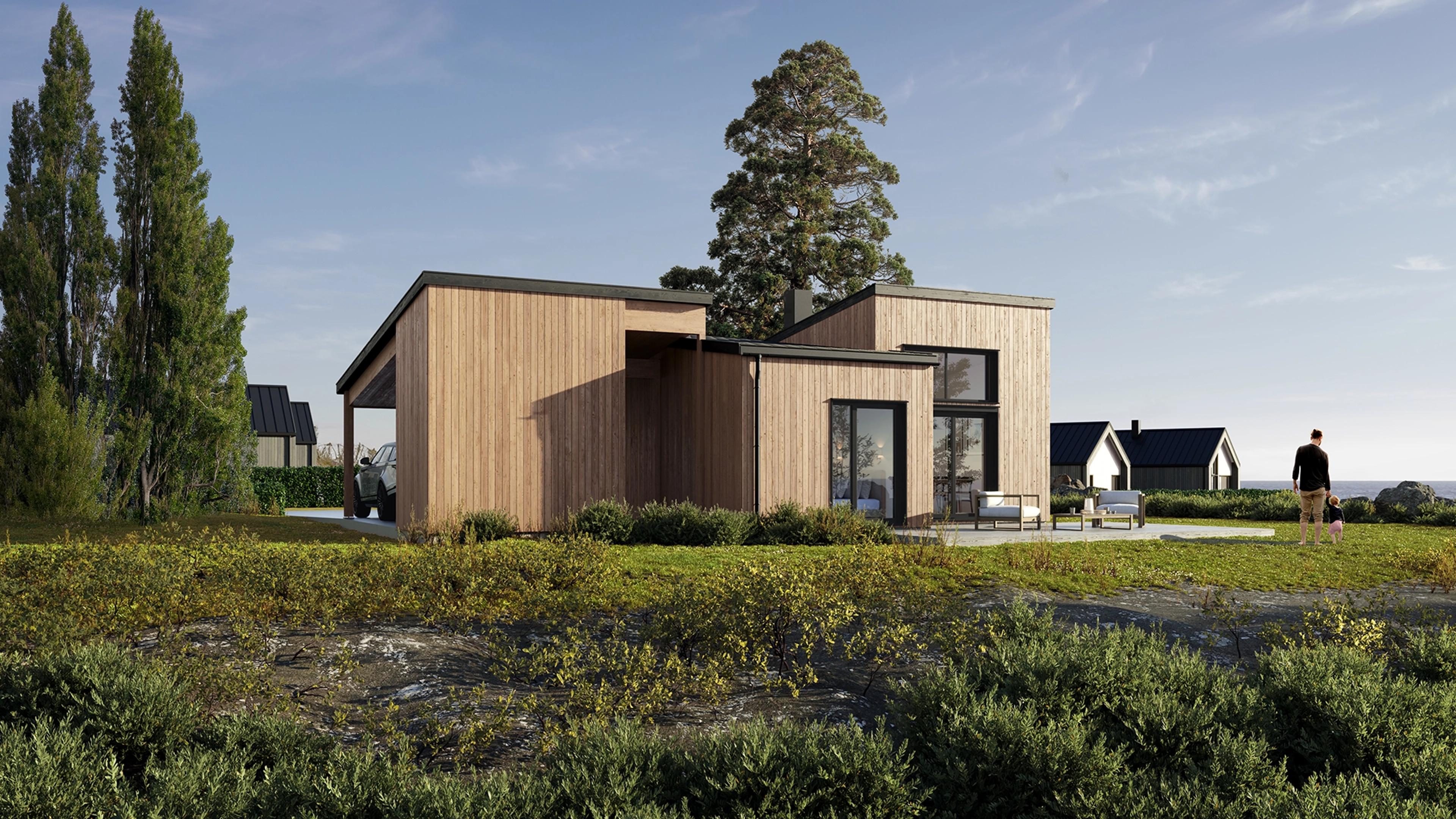 Et gult hus ved vannet og fjell i bakkant