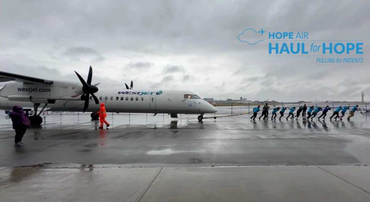 The Brightsquid team pulling a WestJet aircraft at Hope Air's Haul for Hope