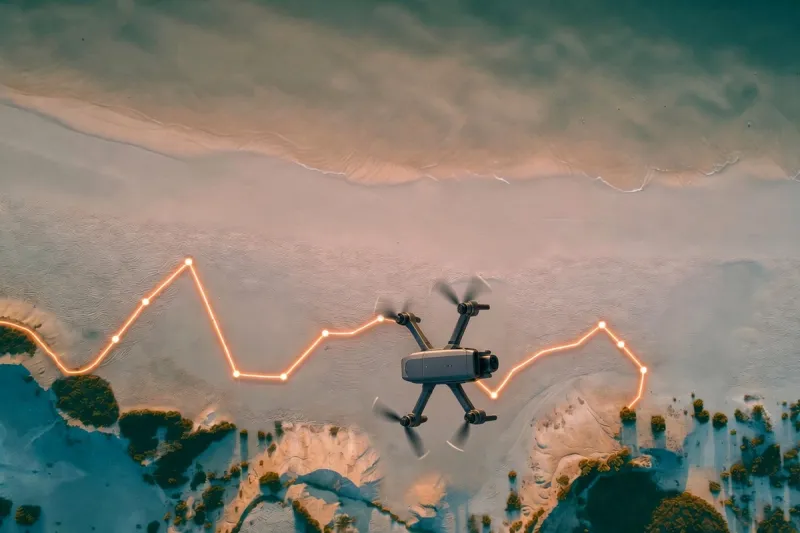 drone hovering over a beach