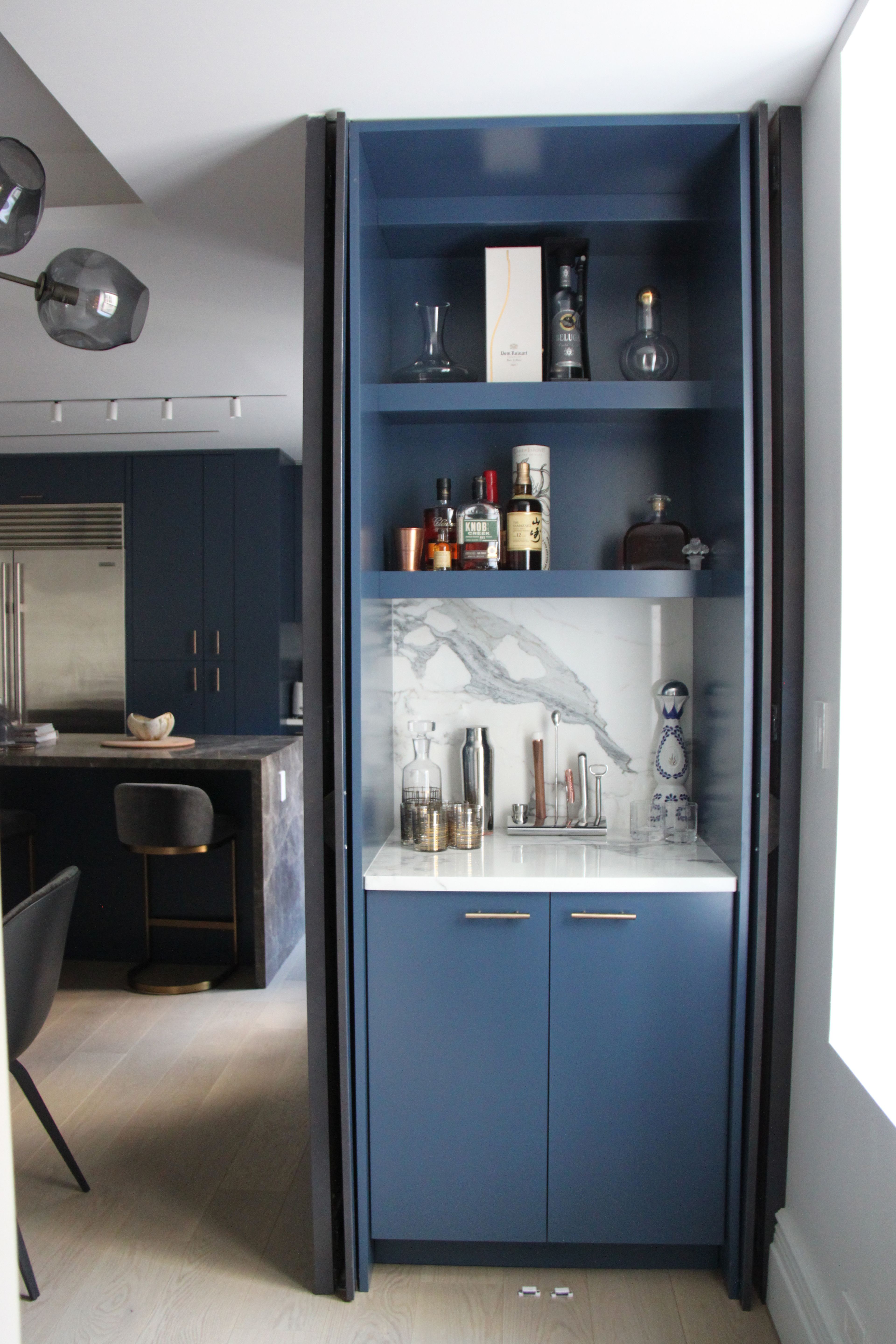 An open cabinet displaying the bar and storage.