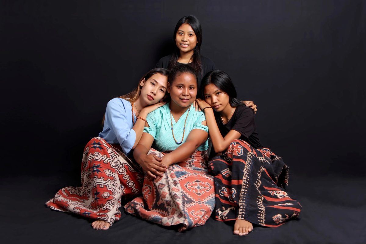 Four women together wearing patterned Sumbanese Ikat