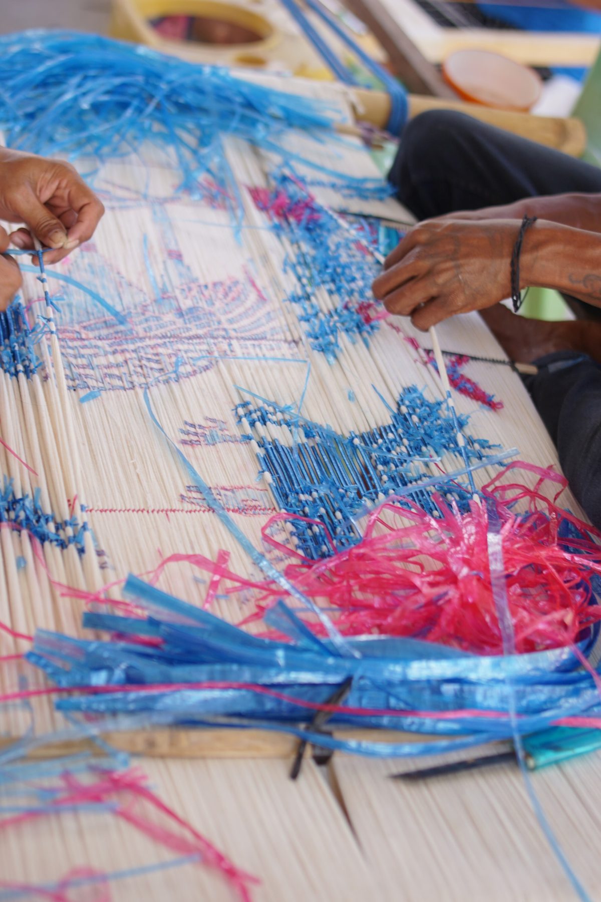 A close view of blue and pink resist ties on a drawn motif