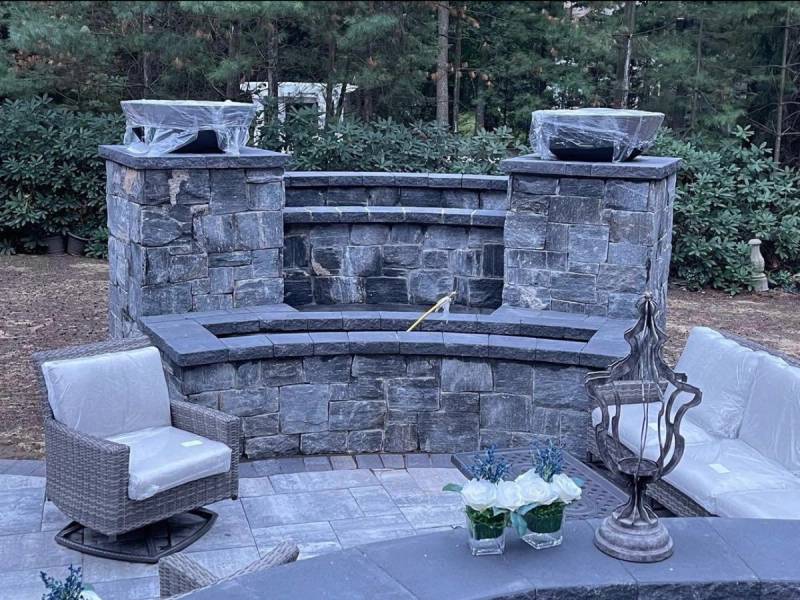 Custom stone seating area with curved bench built from cut stone blocks