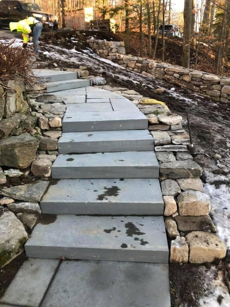 Bluestone slab steps with dry-stacked fieldstone cheek walls ascending wooded hillside