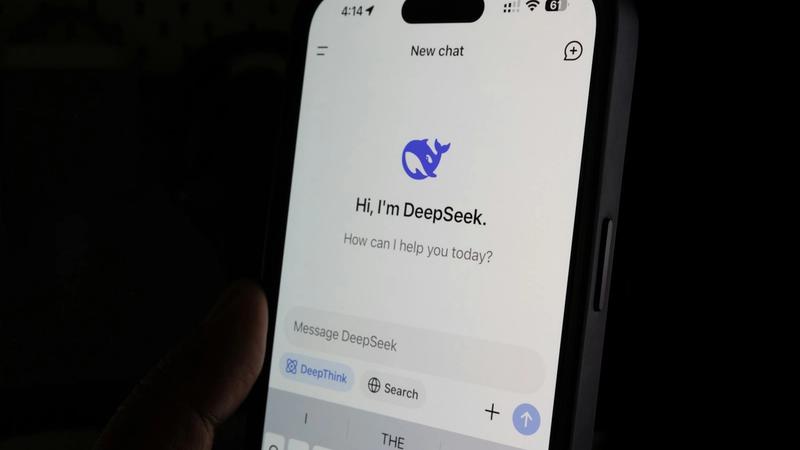 A close-up image of a smartphone displaying a chat interface for an application called DeepSeek. The screen shows a greeting message and a prompt for user interaction.