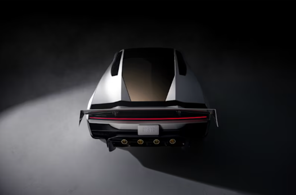 The image depicts the rear view of a modern sports car, showcasing its sleek design and distinctive features. The lighting highlights the contours and aerodynamic elements of the vehicle, emphasizing its performance-oriented aesthetics.