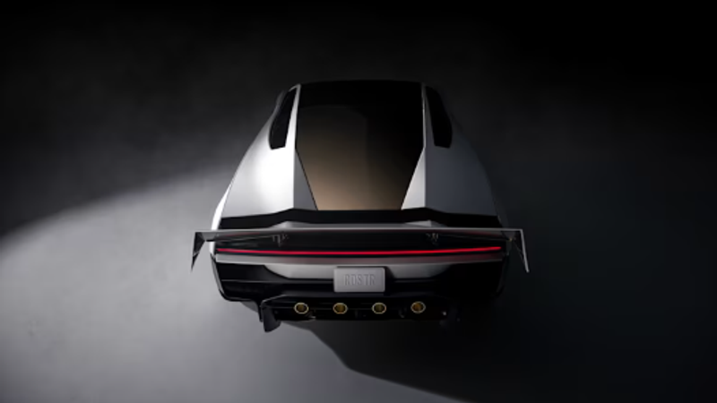 The image depicts the rear view of a modern sports car, showcasing its sleek design and distinctive features. The lighting highlights the contours and aerodynamic elements of the vehicle, emphasizing its performance-oriented aesthetics.