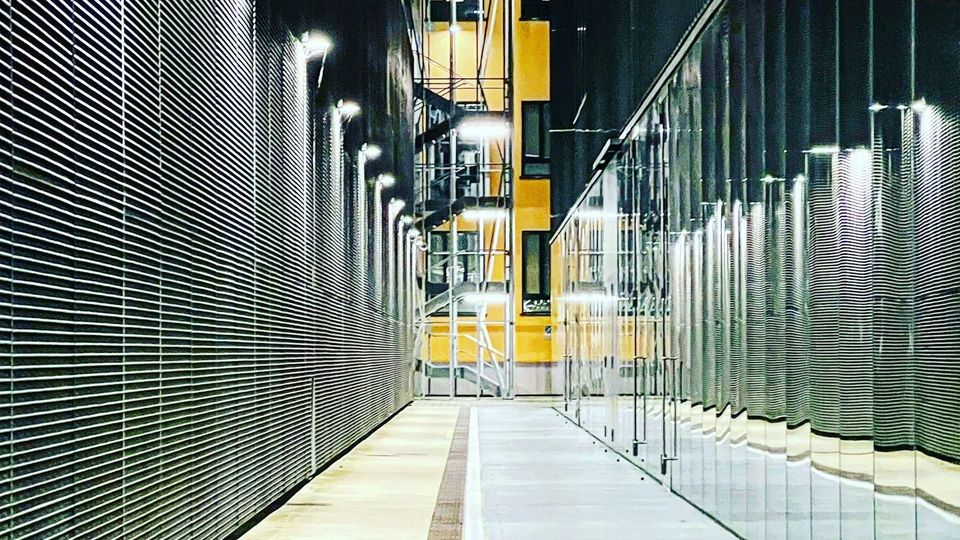 a long hallway with a clock on the side of it