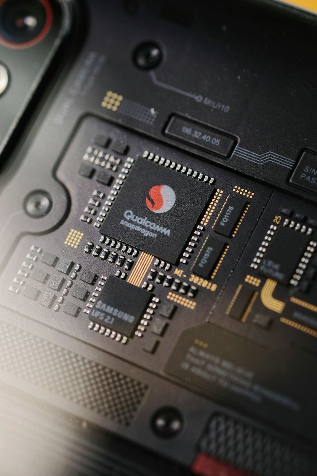 The image showcases a close-up view of a smartphone's internal circuitry, prominently featuring a Qualcomm Snapdragon processor alongside Samsung components. The intricate design highlights modern technology used in mobile devices. — Credit: Photo by Phước Sang on Unsplash