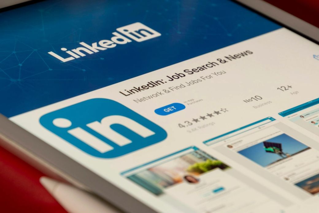 The image shows a close-up of a tablet displaying the LinkedIn app interface. It highlights the app's features for job searching and networking. — Credit: Photo by Souvik Banerjee / Unsplash