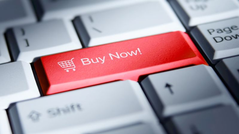 The image features a close-up view of a computer keyboard with a prominent red key labeled 'Buy Now!'. This key is designed to attract attention for online purchasing.