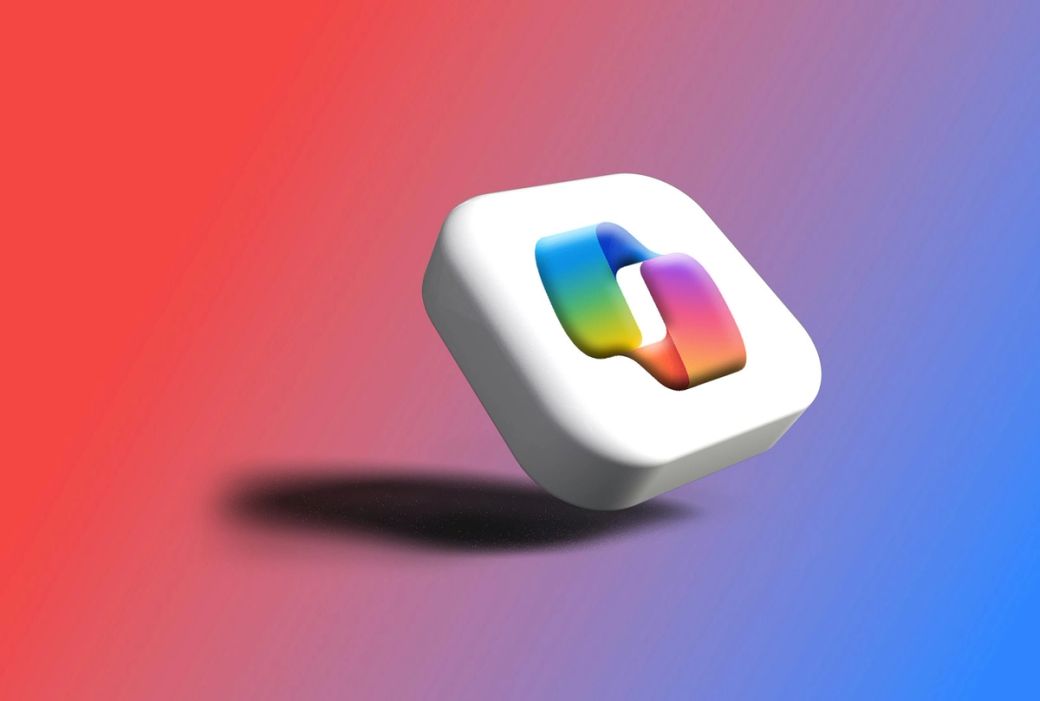 The image features a colorful, stylized logo that appears to float against a gradient background of red and purple. The logo has a modern design, suggesting a tech-oriented theme. — Credit: Photo by Rubaitul Azad / Unsplash