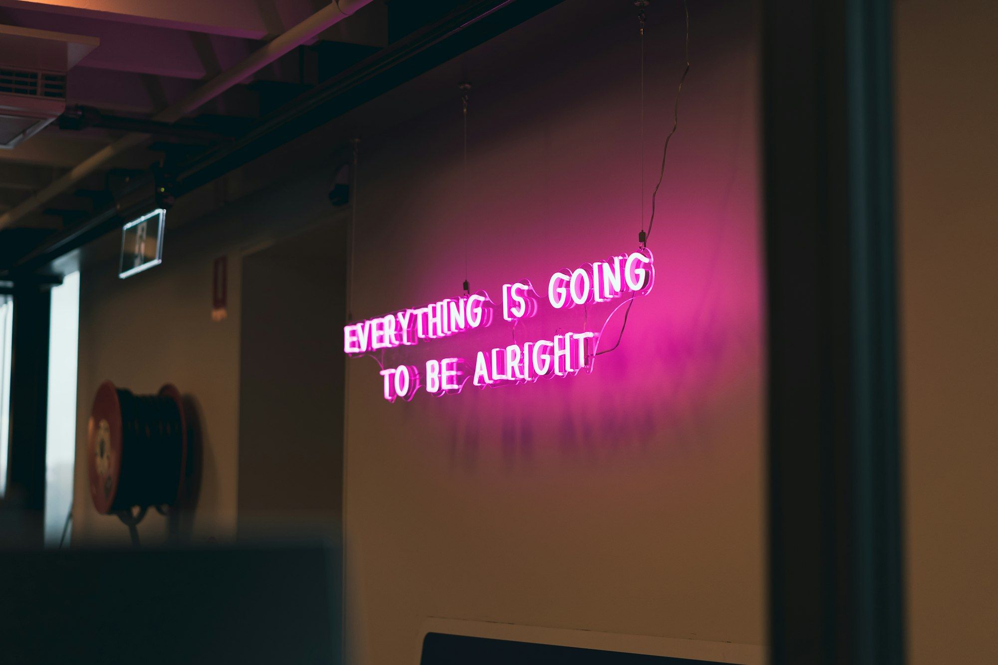 A neon sign, "Everthing is going to be alright"