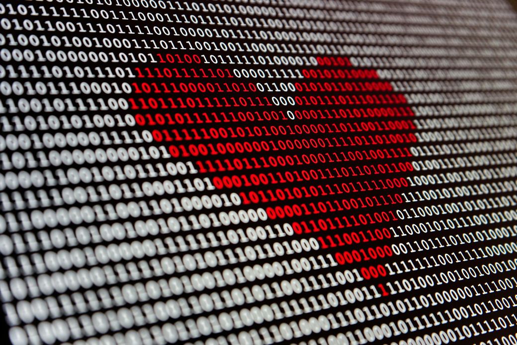 Digital love: a red love heart drawn in binary code