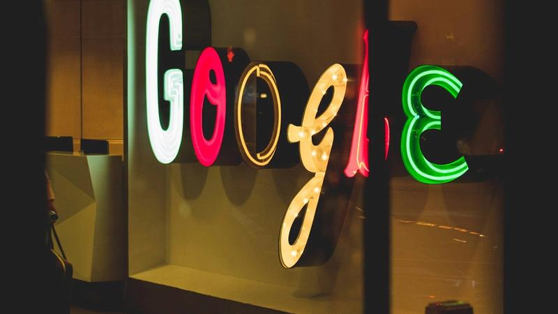The image showcases the illuminated and colorful signage of Google, featuring different colored letters in a decorative style. The bright lights create a vibrant and inviting atmosphere around the brand's name.