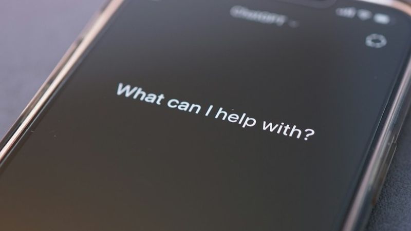 Phone screen asks: "what can i help with?"