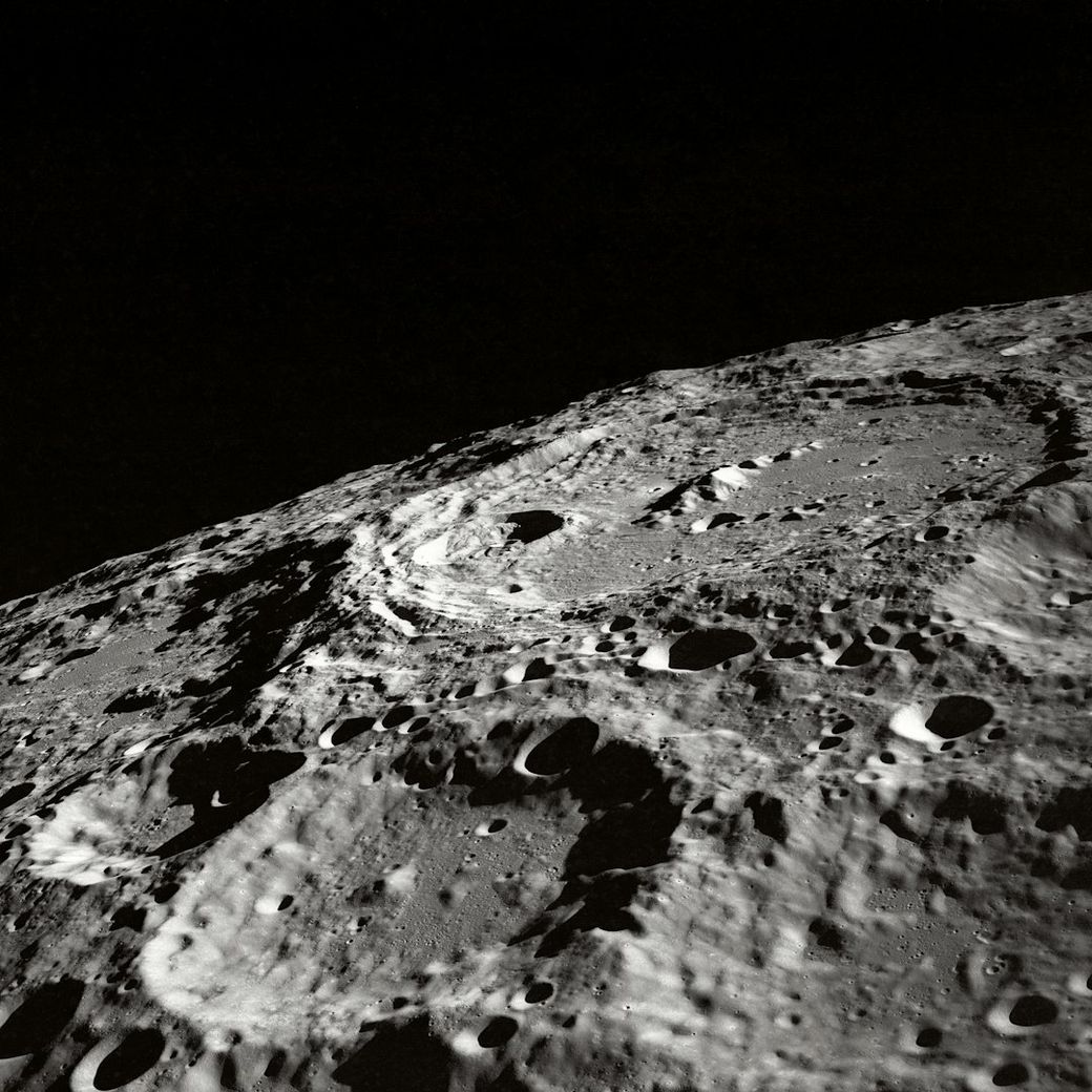 The image depicts a close-up view of the moon's surface, showcasing its craters and rugged terrain. The contrast between light and shadow emphasizes the texture of the lunar landscape. — Credit: Photo by NASA on Unsplash