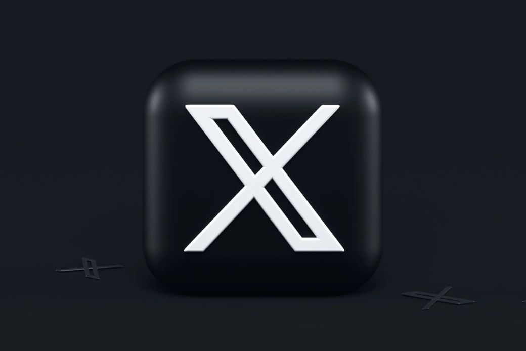 A stylized emblem of the letter 'X' displayed on a dark background, suggesting modern design elements. The logo conveys a sense of digital innovation. — Credit: Photo by Alexander Shatov / Unsplash