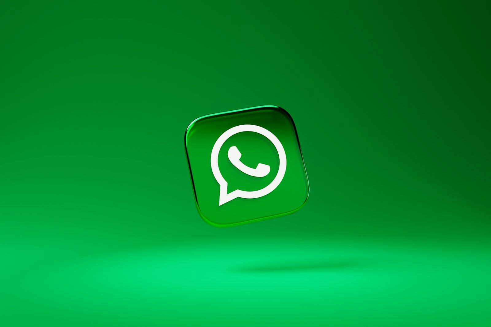 The image features the WhatsApp logo prominently displayed against a vibrant green background. The logo is presented in a three-dimensional style, giving it a modern and dynamic appearance.