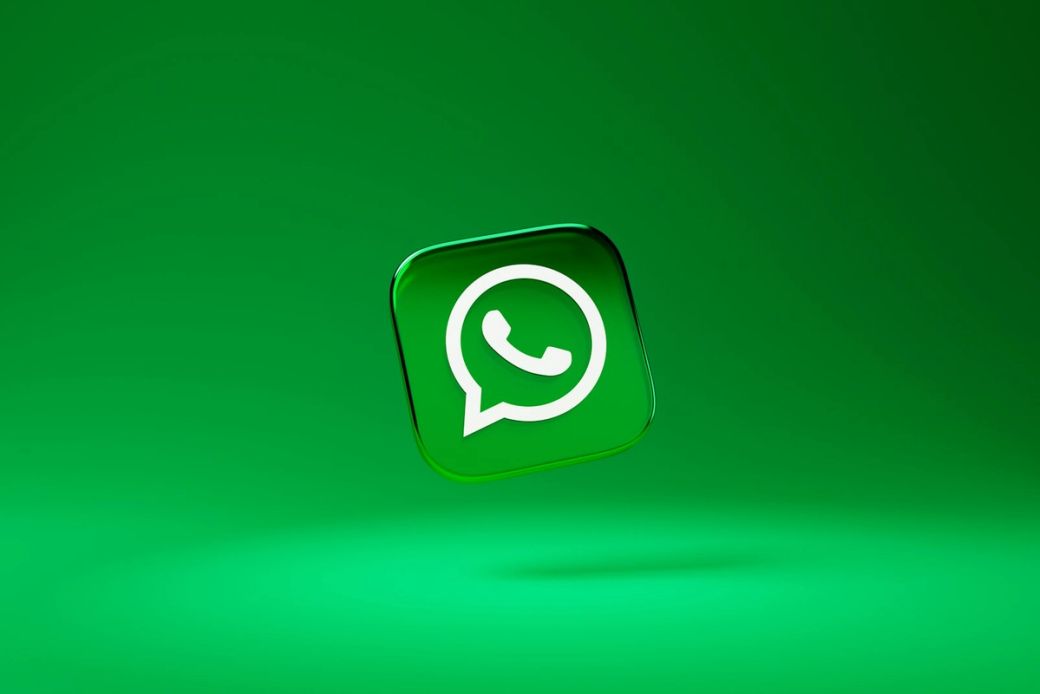 The image features the WhatsApp logo prominently displayed against a vibrant green background. The logo is presented in a three-dimensional style, giving it a modern and dynamic appearance. — Credit: Photo by Dima Solomin / Unsplash