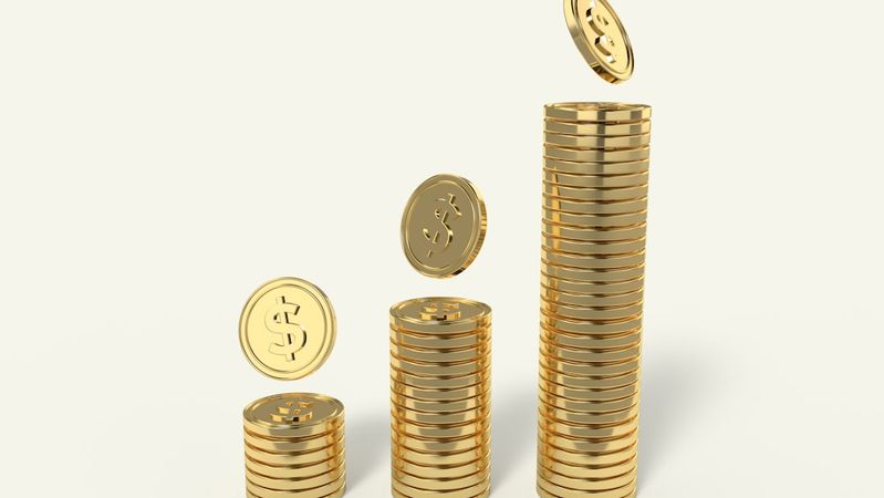 The image depicts golden coins stacked in ascending order, illustrating a concept of wealth accumulation and financial growth. Some coins are shown in mid-air as if they are being added to the stacks.