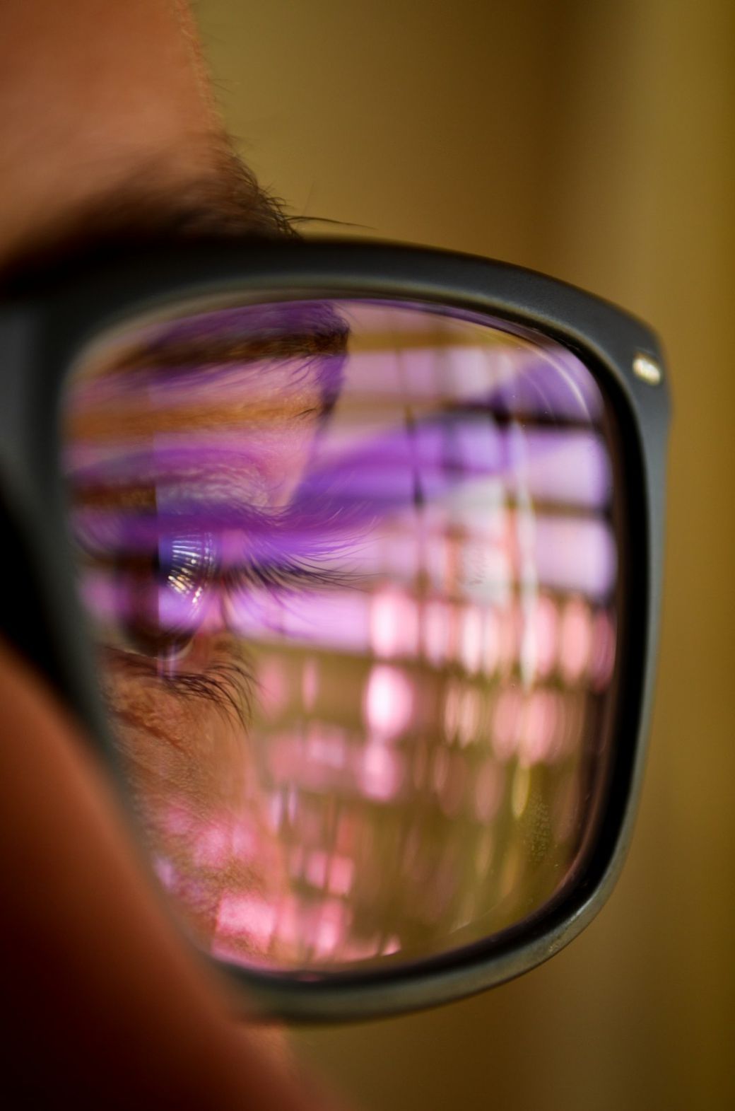 The image captures a close-up of a person's eye reflected in glasses, showcasing colorful light patterns and abstract visuals. The focus is on the intricate details of the eye and the vibrant reflections within the lenses. — Credit: Photo by Ramiro Pianarosa on Unsplash