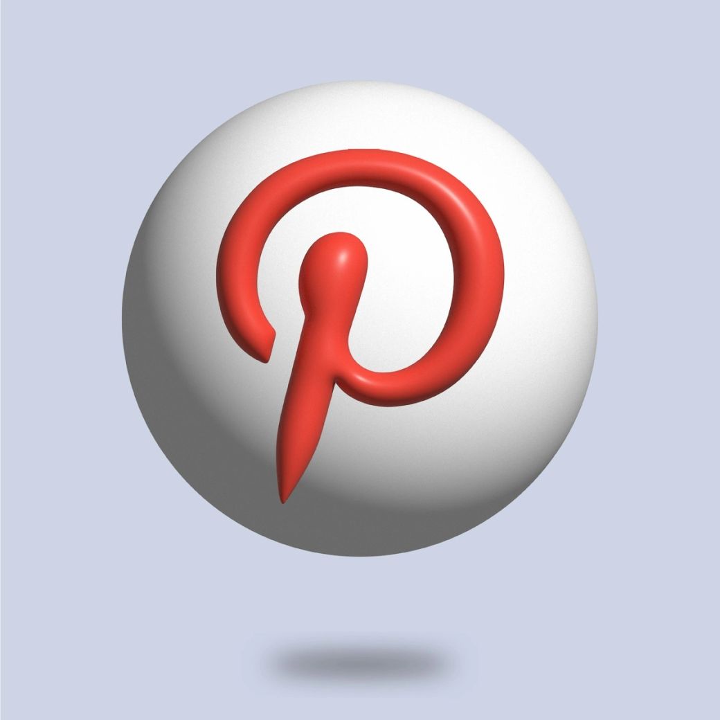 This image features a stylized version of the Pinterest logo prominently displayed on a spherical surface. The logo is depicted in red against a white background, emphasizing its distinctive design. — Credit: Photo by Farhat Altaf / Unsplash