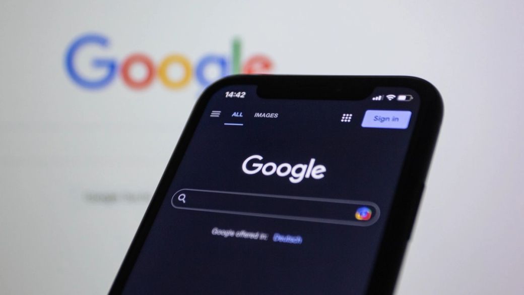 The image shows a smartphone displaying the Google search interface against a blurred background featuring the Google logo. The interface is set to the 'Images' search category. — Credit: Photo by Shutter Speed / Unsplash