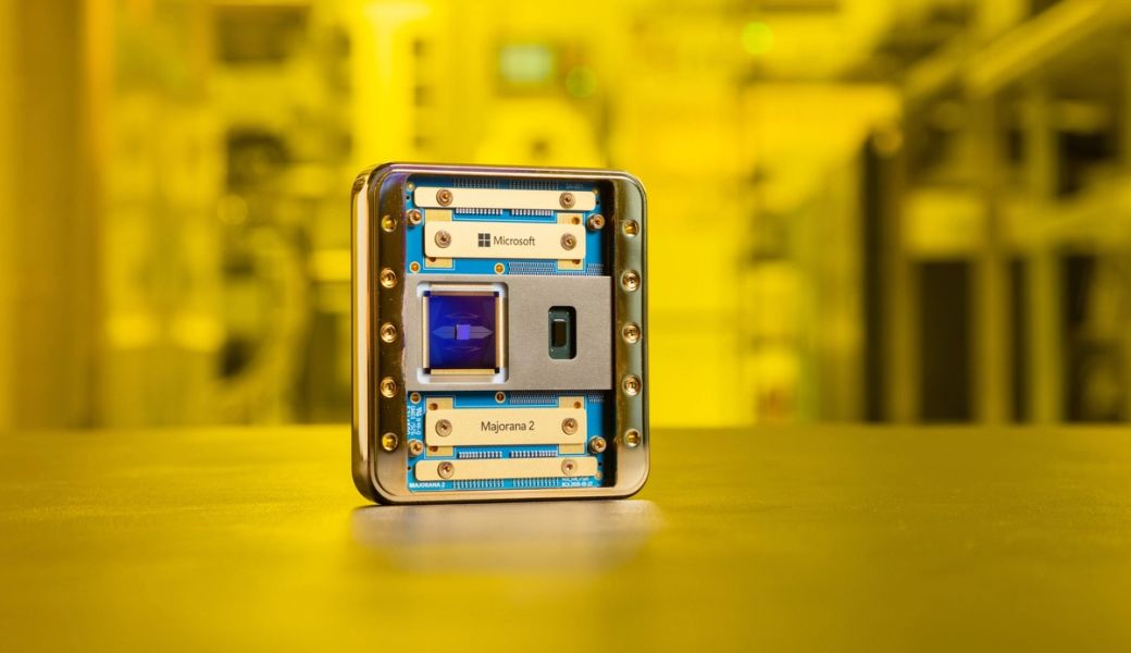 The image features a close-up of a metallic device labeled with 'Microsoft' and 'Marjornan 2'. The device is presented against a blurred background, suggesting a high-tech environment with warm yellow lighting. This setting hints at advancements in technology, possibly related to quantum computing or data processing.
