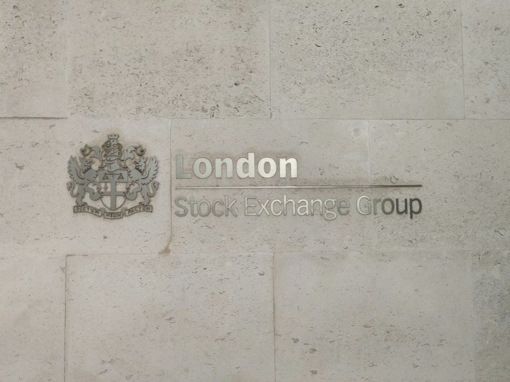 The image shows a wall plaque displaying the name of the London Stock Exchange Group. The plaque features both the name and the emblem of the organization, set against a textured stone background. — Credit: Photo by David Vincent on Unsplash
