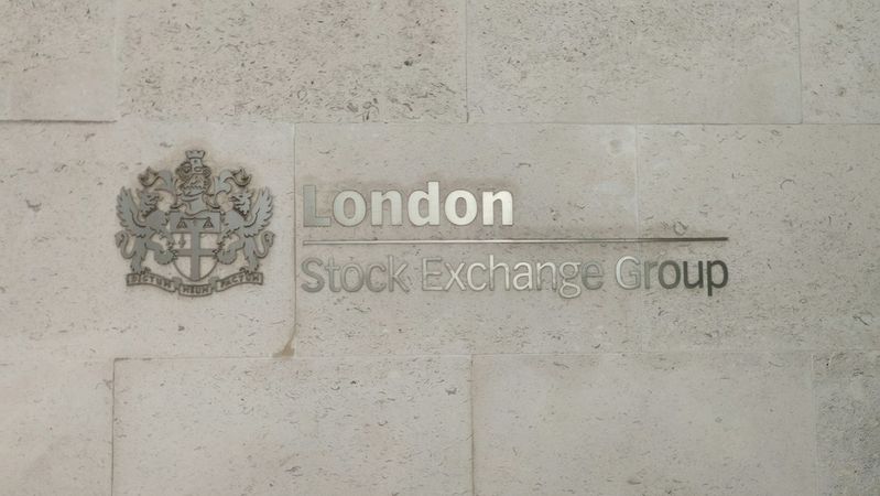 The image shows a wall plaque displaying the name of the London Stock Exchange Group. The plaque features both the name and the emblem of the organization, set against a textured stone background.