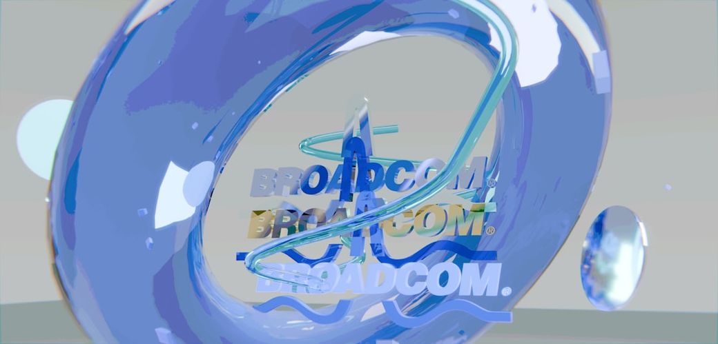 The image features a stylized 3D representation of the Broadcom logo, with a swirling blue element creating a dynamic visual effect. The logo appears multiple times, emphasizing the brand's presence. — Credit: Photo by Brecht Corbeel on Unsplash