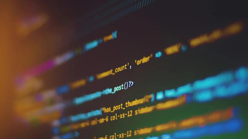 The image displays a close-up view of computer code on a screen, showcasing various programming syntax and functions. The focus is on colorful lines of code, indicating a coding or software development environment.