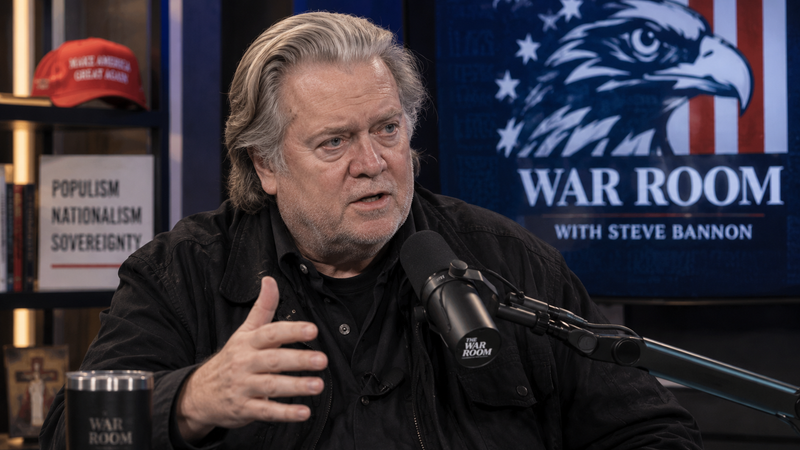 The image features Steve Bannon seated at a microphone in a studio setting. Behind him is a screen displaying the title 'WAR ROOM' alongside an eagle graphic and American flag elements, indicating a politically charged environment. Bannon is captured in a moment of discussion, emphasizing themes of populism and nationalism.