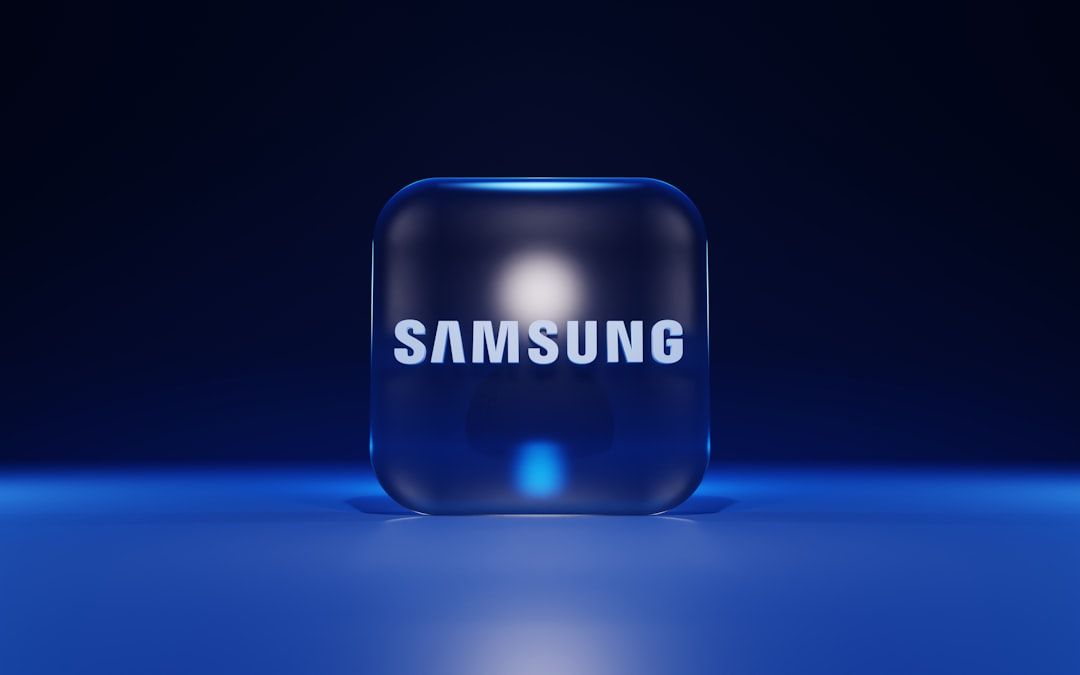 The image features a three-dimensional, illuminated cube with the Samsung logo prominently displayed on it. The background is a deep blue, creating a modern and tech-focused aesthetic.