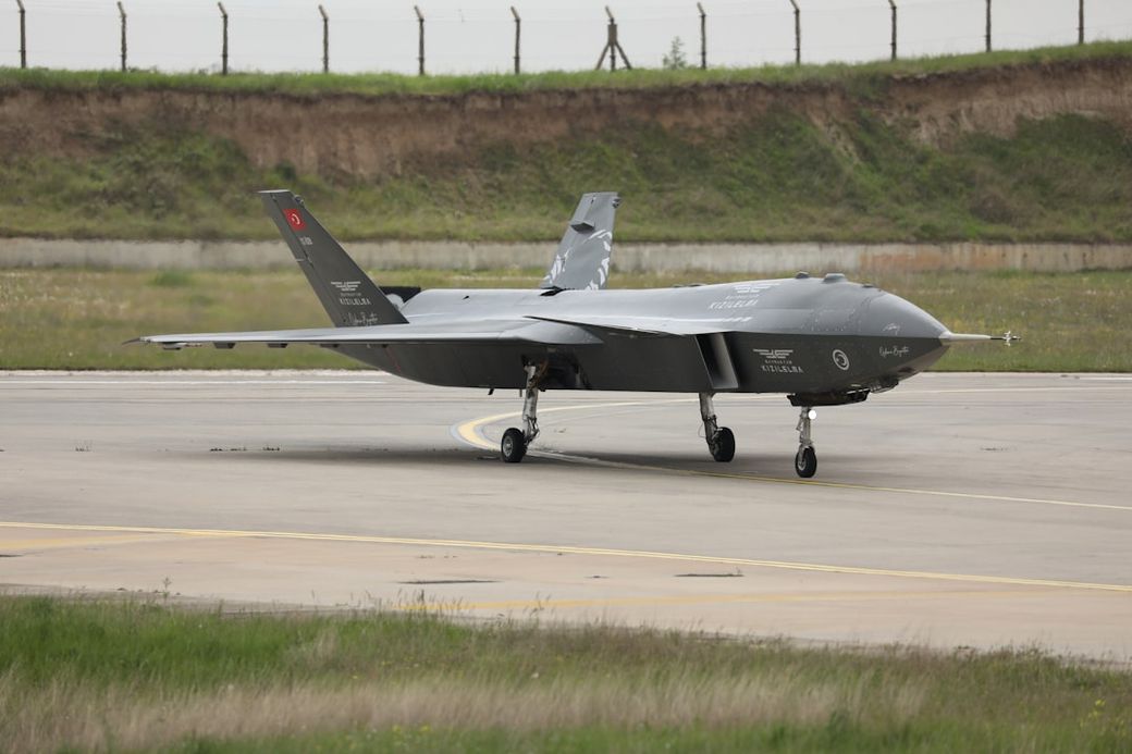 An unmanned aerial vehicle (UAV) is positioned on a runway at an airfield. The aircraft bears markings indicative of military use and is ready for takeoff, showcasing its sleek design and advanced technology. — Credit: Photo by Enderun Defence on Unsplash