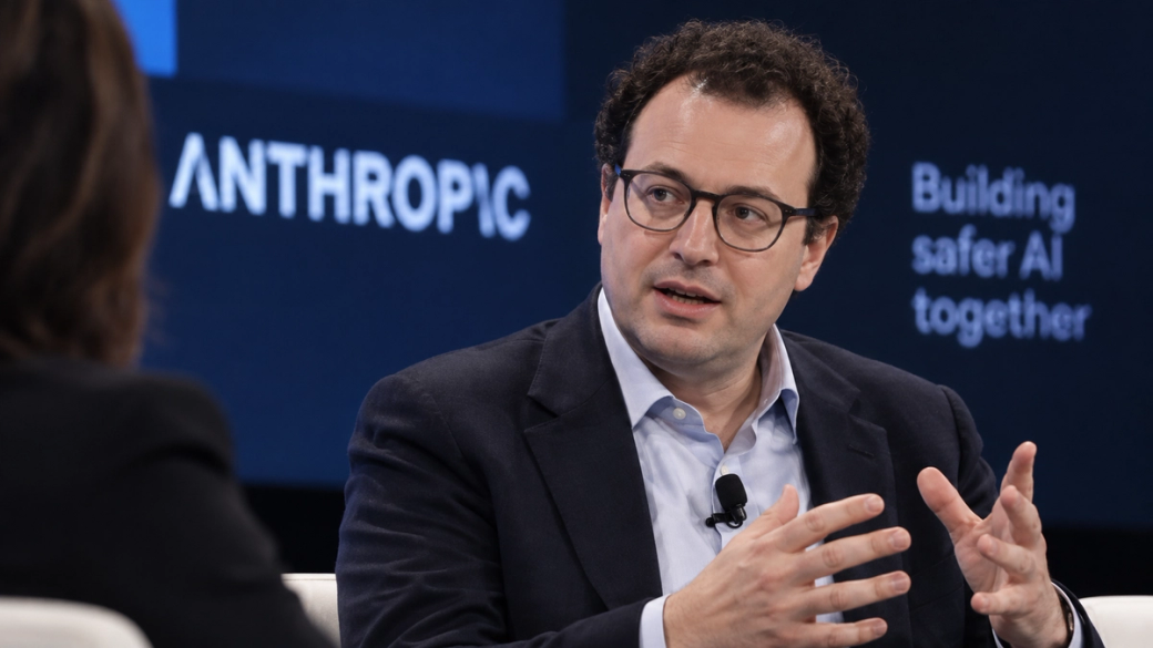 The image features Dario Amodie speaking in a conversational setting, likely during a panel discussion or interview. He appears to be discussing themes related to artificial intelligence, with a focus on collaboration and safety in AI development.