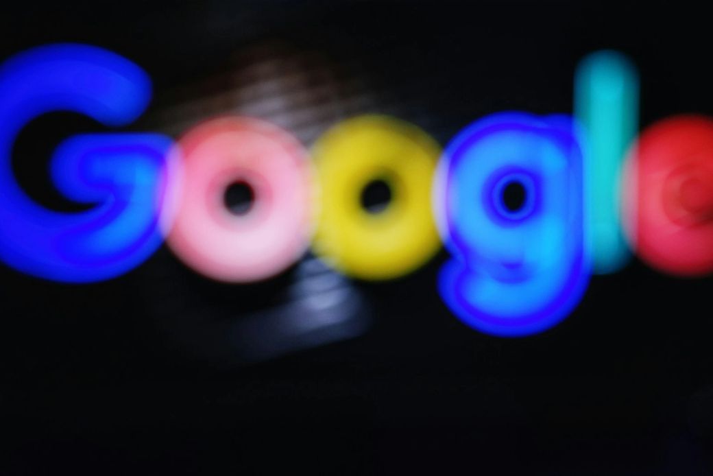 The image features a blurred depiction of the Google logo prominently displayed in various colors. The focus appears to be on the logo itself, emphasizing the brand's identity through its distinctive lettering. — Credit: Photo by Maik Winnecke / Unsplash